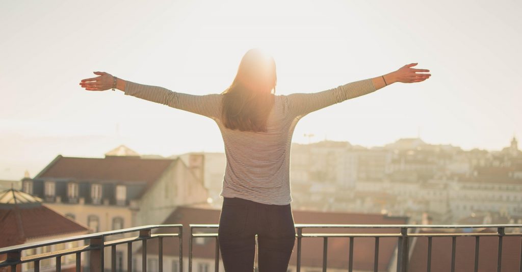 woman balcony sun